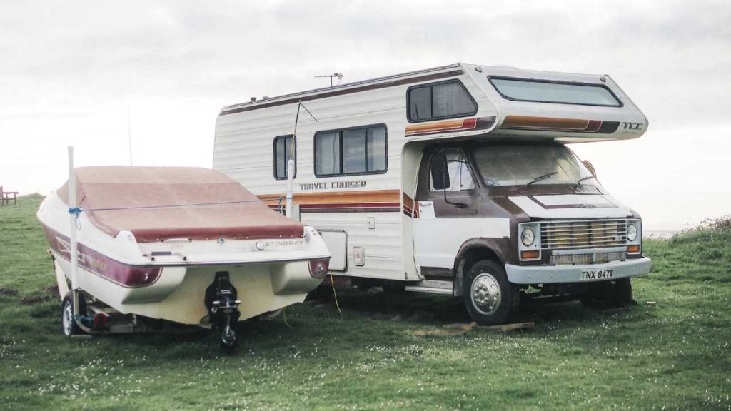 a motor home is parked next to a trailer